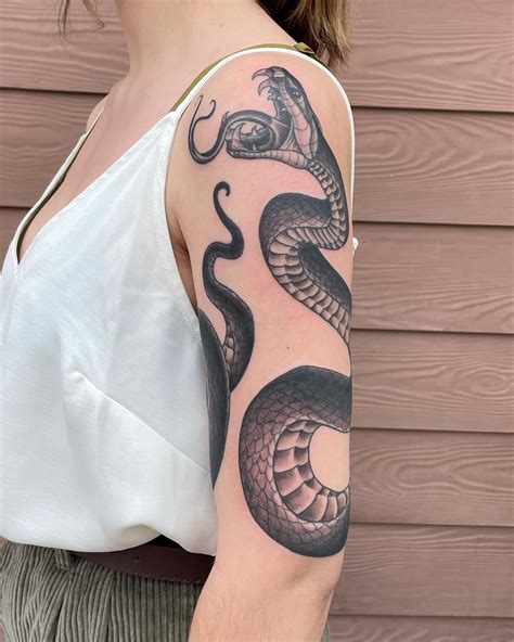 snake wrapped around arm tattoo